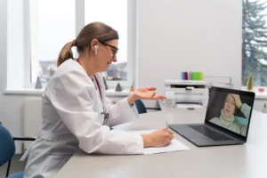 doctor teleconsulting patient laptop scaled 1