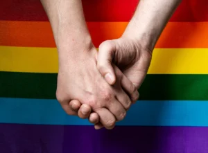 closeup shot hands with lgbt flag background