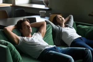 happy millennial couple relaxing comfortable couch together home 1