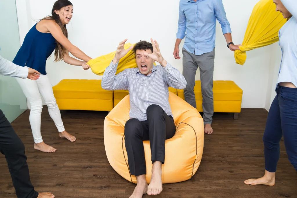 Child Counselling in Gurgaon 19 joyful people beating their friend with pillows