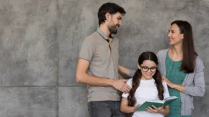 low angle parents helping girl read