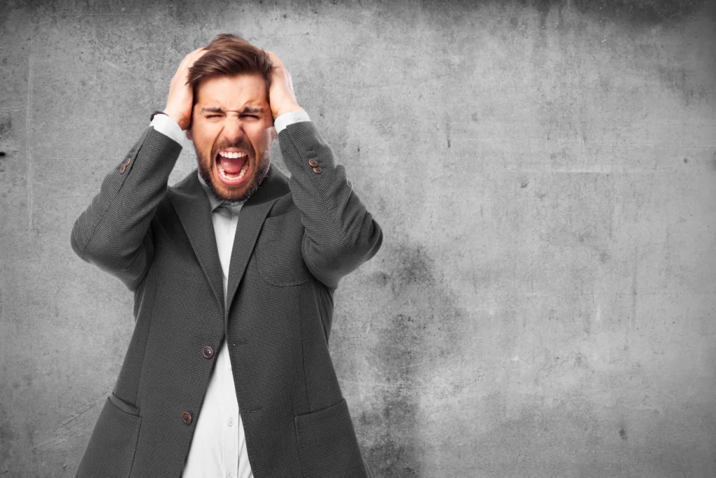 man holding his head with hands