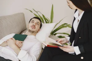 man sitting psychologist s office talking about problems