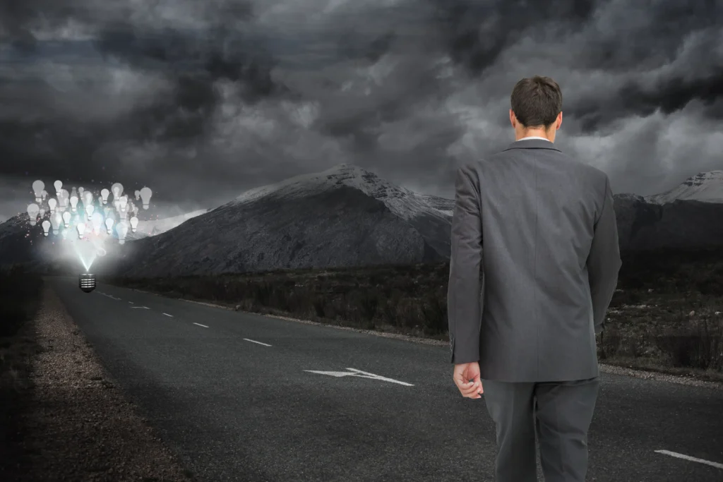 man walking along dark road