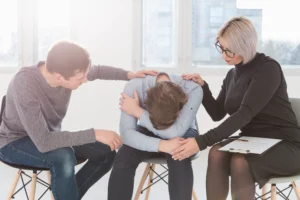 man woman trying console patient