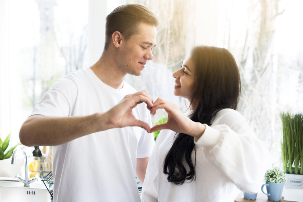 multiracial couple making love gesture looking each other 1