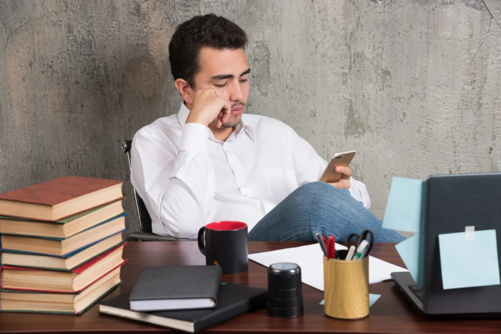 Self-Improvement Counselling in Gurgaon 22 serious businessman playing with telephone office desk