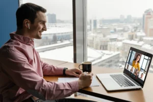 side view man having online video call with coworkers 1