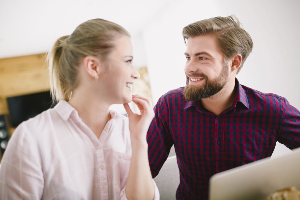 smiling man woman laptop