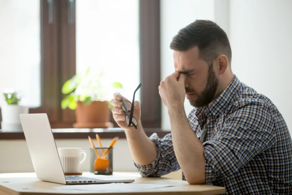 Anxiety Counseling in Gurgaon 22 stressed male massaging nose bridge suffering from headache 1