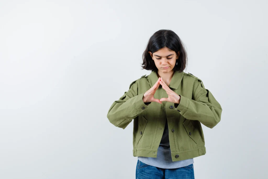 Child Counselling in Gurgaon 22 young girl showing insurance gesture grey sweater khaki jacket jean pant looking serious front view 1