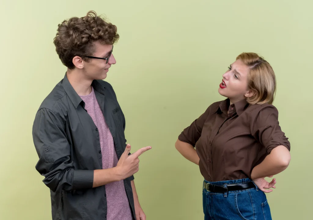 young beautiful couple wearing casual clothes man woman quarreling standing light wall