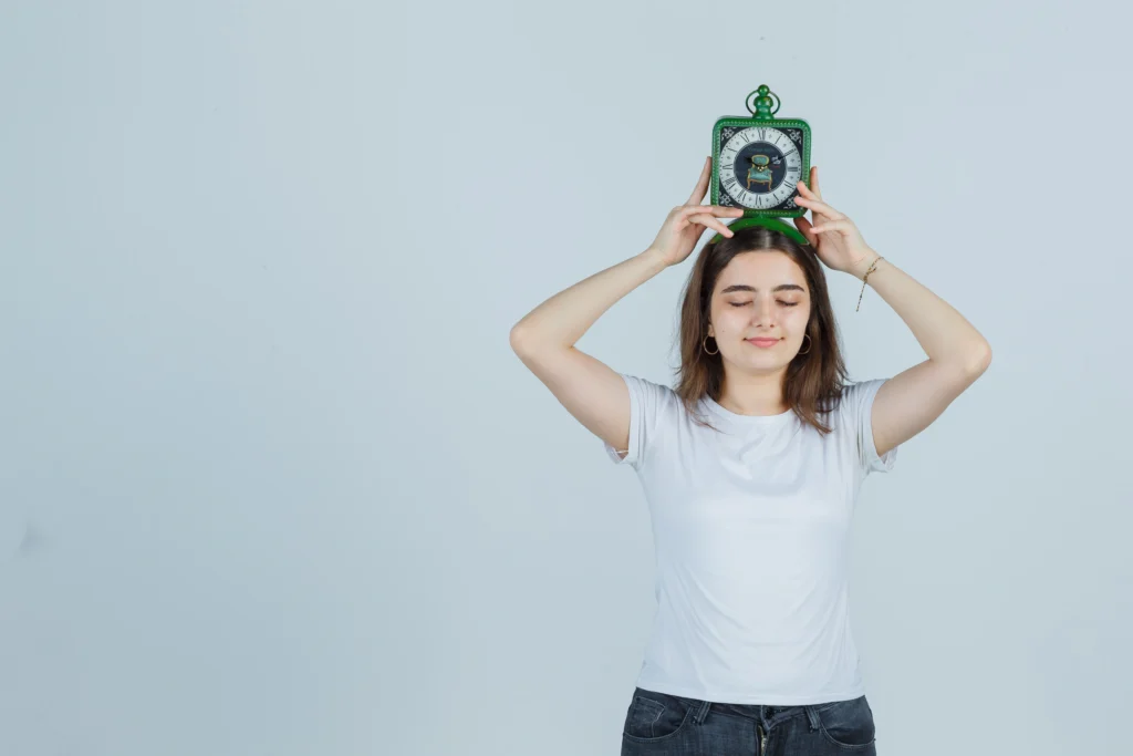 young girl holding clock head t shirt jeans looking funny front view