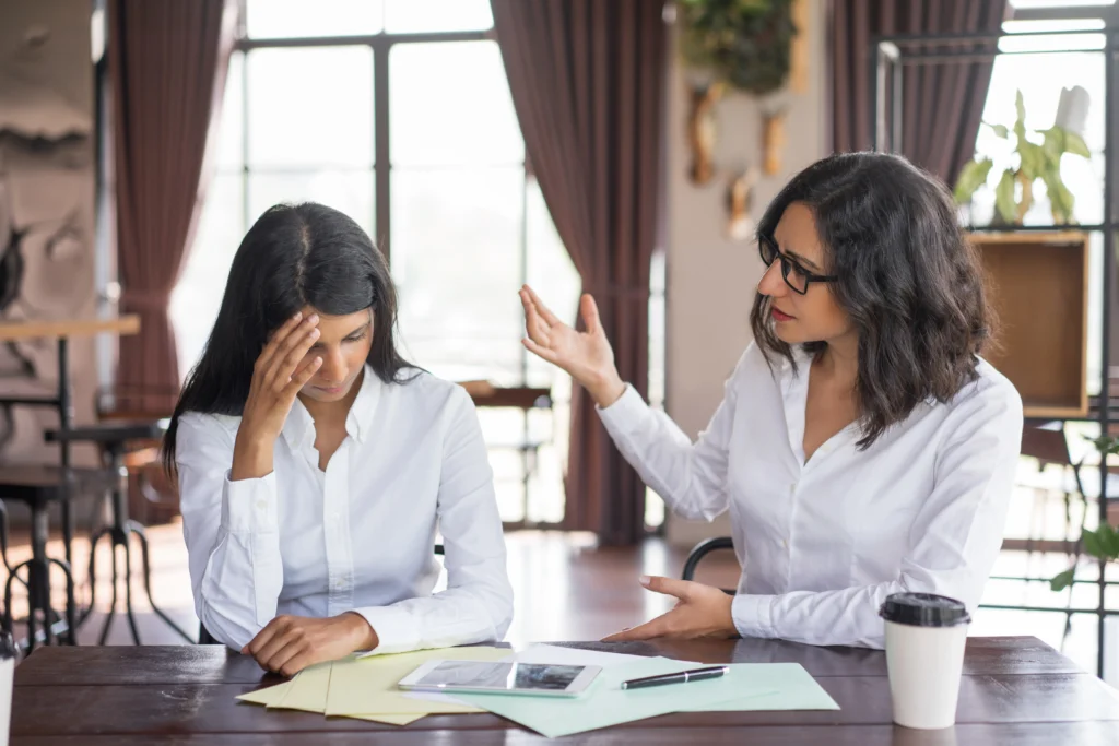 disappointed business woman scolding colleague