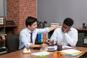 Depression Counseling in Delhi 30 front view two businessmen discussing project while one putting hand other ones shoulder