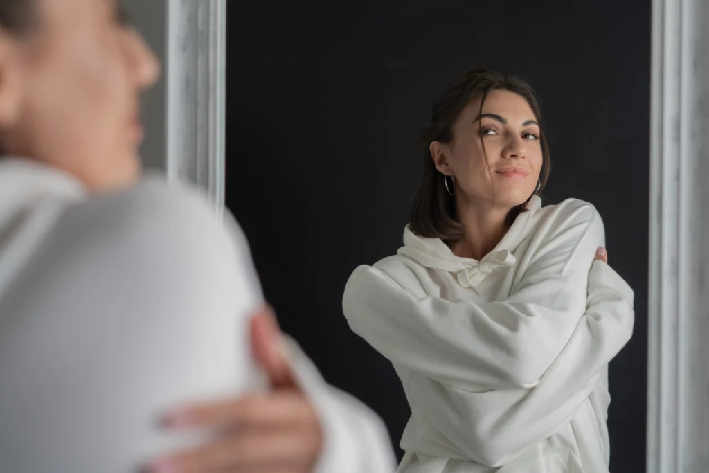 young woman white hoodie posing mirror
